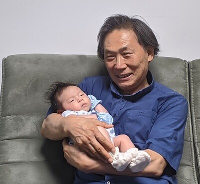 첫 손녀 단유를 안아보고 있는 할아버지 김상윤씨. 가족 제공